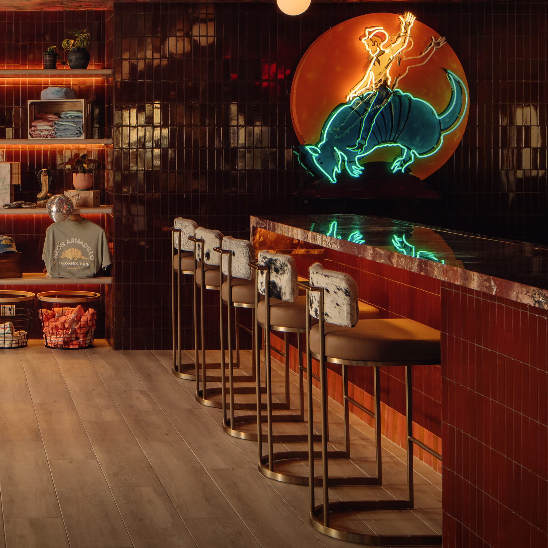 Luxury upholstered cowhide bar stools in a modern rustic kitchen featuring custom western-inspired furniture and premium craftsmanship.
